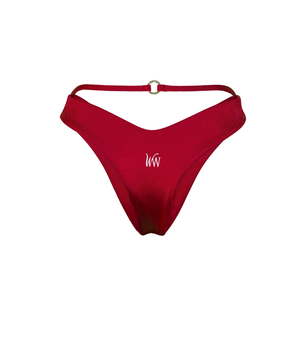 The back of a bordeaux colord swimwear bottom with a string detail that has a gold branded hardware ring on the back as well as a white WW logo in the middle of the bikini bottom.