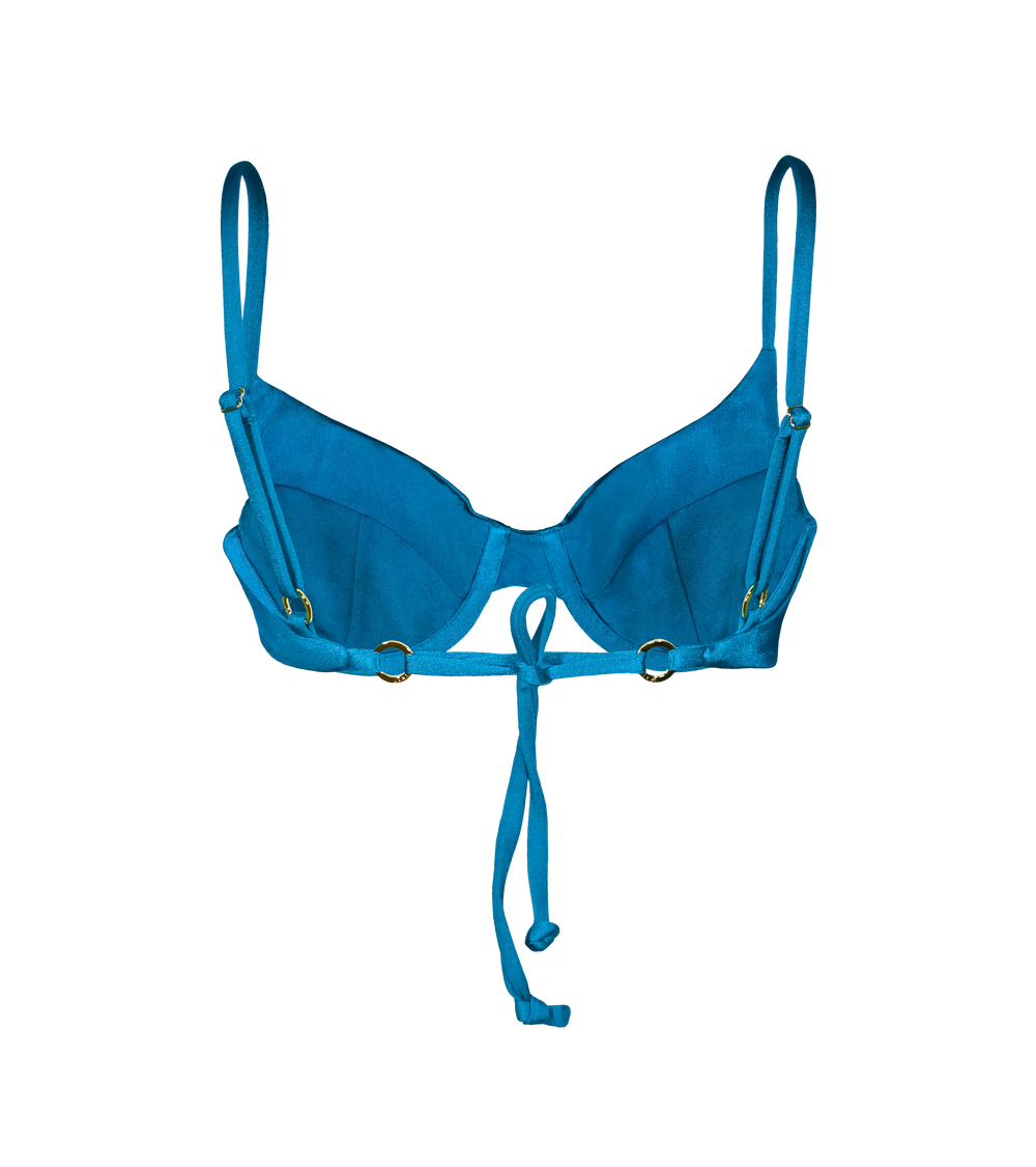 The back of the bright blue underwire bikini top with adjustable straps with gold branded ring hardware and a tie-back detail for a customizable fit.