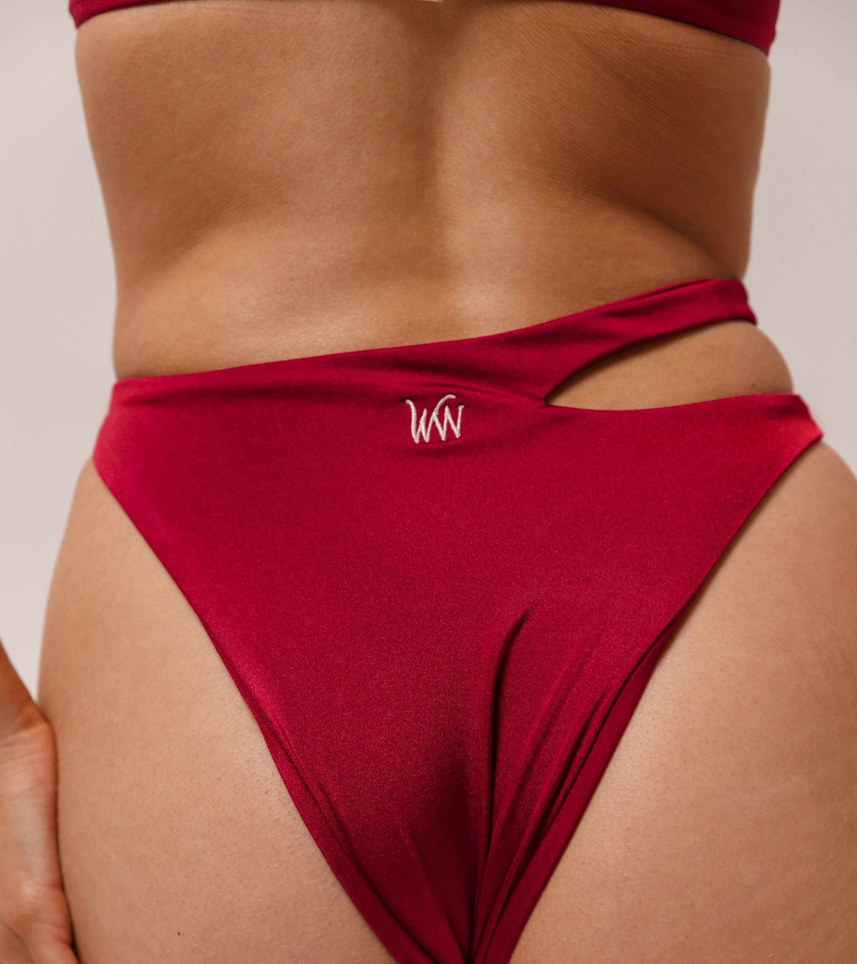 Close-up view of the Wealthywet logo on 1966 swimwear bottom in Bordeaux
