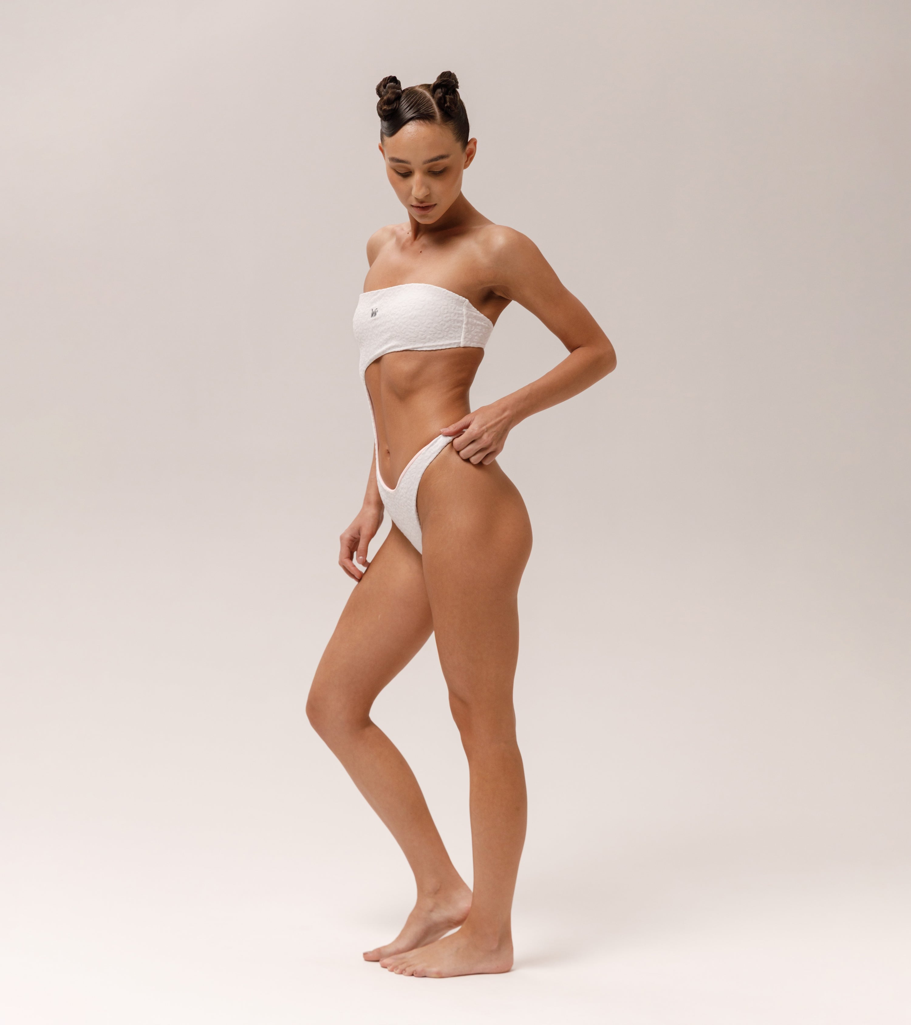 Model is wearing a Wealthywet 1971 one piece swimsuit in White Savannah