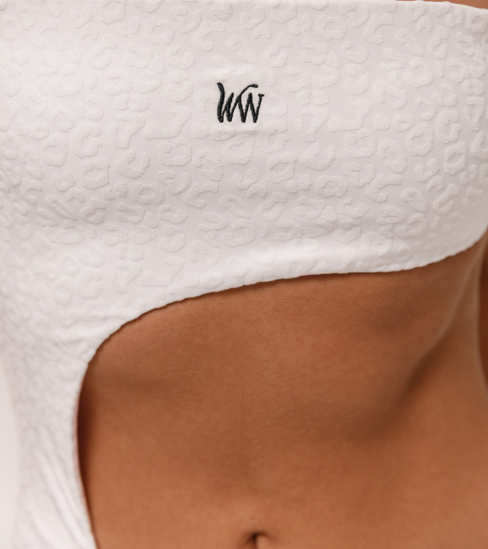 Close-up of the Wealthywet logo 1971 one piece swimsuit in White Savannah